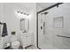 Modern bathroom with white vanity, walk-in shower, and marble tile at 7220 Elderly Ave, Las Vegas, NV 89131