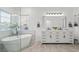 Elegant bathroom with double vanity, soaking tub, and walk-in shower at 7220 Elderly Ave, Las Vegas, NV 89131