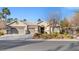 Single-story house with three-car garage, mature landscaping, and desert landscaping at 7220 Elderly Ave, Las Vegas, NV 89131