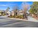 House exterior with three-car garage, mature landscaping, and desert landscaping at 7220 Elderly Ave, Las Vegas, NV 89131