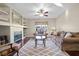 Living room with hardwood floors, built-in shelving, fireplace, and comfortable seating at 7220 Elderly Ave, Las Vegas, NV 89131