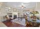 Living room with hardwood floors, built-in shelving, fireplace, and comfortable seating at 7220 Elderly Ave, Las Vegas, NV 89131