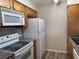 Efficient kitchen, white appliances and wood cabinets at 730 Oakmont Ave # 904, Las Vegas, NV 89109