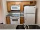 Clean kitchen with white appliances and wood cabinets at 730 Oakmont Ave # 904, Las Vegas, NV 89109