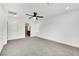 Bright bedroom featuring grey carpet and access to bathroom at 7883 Bethel Heights Ln, Las Vegas, NV 89113