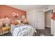 Bright bedroom featuring a light teal bed frame and coral walls at 791 Ruby Sedona Ave, North Las Vegas, NV 89081