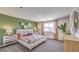 Main bedroom with green accent wall and large bed at 791 Ruby Sedona Ave, North Las Vegas, NV 89081