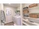 Laundry room with washer, dryer, shelving, and ample storage at 791 Ruby Sedona Ave, North Las Vegas, NV 89081