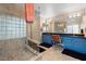 Bathroom with double vanity, blue cabinets, and glass-block window at 7944 Marbella Cir, Las Vegas, NV 89128