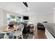 Bright dining area with wooden table and chairs, adjacent to living room at 7944 Marbella Cir, Las Vegas, NV 89128