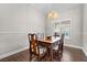 Formal dining room with wood table, chandelier, and hardwood floors at 7944 Marbella Cir, Las Vegas, NV 89128