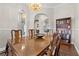 Formal dining room with wood table, chandelier, and built-in bookcase at 7944 Marbella Cir, Las Vegas, NV 89128