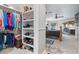 Spacious walk-in closet with shelving and hanging rods for clothes and shoes at 7944 Marbella Cir, Las Vegas, NV 89128