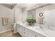 Double vanity bathroom with a quartz countertop and tiled floors at 830 Carnegie St # 1821, Henderson, NV 89052