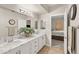 Bathroom featuring double sinks with a decorative plant on the marble countertop at 830 Carnegie St # 1821, Henderson, NV 89052