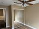 Bright bedroom with mirrored closet doors and ceiling fan at 9712 Tiaquinn Ave # 101, Las Vegas, NV 89129