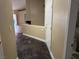 Clean hallway with dark tile floors and neutral walls at 9712 Tiaquinn Ave # 101, Las Vegas, NV 89129