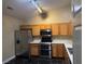 Kitchen with stainless steel appliances and wood cabinets at 9712 Tiaquinn Ave # 101, Las Vegas, NV 89129