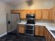 Kitchen with stainless steel appliances and wood cabinets at 9712 Tiaquinn Ave # 101, Las Vegas, NV 89129