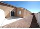 Backyard with gravel and concrete patio and a sliding glass door at 1025 Chestnut Bay Ave, North Las Vegas, NV 89031