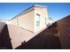 Side yard with gravel landscaping and a partial view of the home's exterior at 1025 Chestnut Bay Ave, North Las Vegas, NV 89031