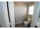 Cozy half-bathroom with gray flooring and a window offering natural light at 1025 Chestnut Bay Ave, North Las Vegas, NV 89031