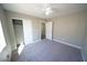 Standard bedroom with closet space, neutral walls, carpet, and ceiling fan at 1025 Chestnut Bay Ave, North Las Vegas, NV 89031