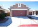 Exterior shot featuring a two-car garage, wide driveway, and desert landscaping against a blue sky at 1025 Chestnut Bay Ave, North Las Vegas, NV 89031