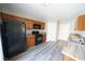 Updated kitchen features black appliances, wood cabinetry, and a breakfast bar overlooking the living area at 1025 Chestnut Bay Ave, North Las Vegas, NV 89031