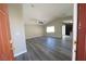 Interior view of the living room showcasing wood-look flooring and a view into the kitchen at 1025 Chestnut Bay Ave, North Las Vegas, NV 89031