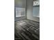 Living room with wood-look flooring and large windows at 10337 Adams Chase St, Las Vegas, NV 89183