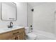 Stylish bathroom with a chevron-patterned tile shower surround, light wood vanity, and black fixtures at 110 Palo Verde Dr, Henderson, NV 89015