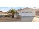 Front view of charming house with palm tree and driveway at 116 Crescent Bay St, Henderson, NV 89012