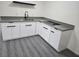 Modern kitchen with white shaker cabinets and grey countertops at 116 W Victory Rd, Henderson, NV 89015