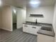 Kitchenette with updated appliances, gray counters and wood-look floors at 116 W Victory Rd, Henderson, NV 89015