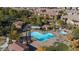 An aerial view of community pool with cabanas, trees, and walkways at 11870 Tevare Ln # 2086, Las Vegas, NV 89138