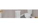 Modern bathroom featuring white toilet and small cabinet at 11870 Tevare Ln # 2086, Las Vegas, NV 89138