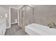 Clean bathroom featuring soaking tub and separate tiled shower with glass door at 11870 Tevare Ln # 2086, Las Vegas, NV 89138