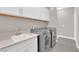 Functional laundry room equipped with modern washer, dryer, and sink area at 11870 Tevare Ln # 2086, Las Vegas, NV 89138
