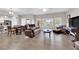 Spacious living room featuring wood floors, large windows, and comfortable leather seating at 11870 Tevare Ln # 2086, Las Vegas, NV 89138