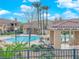 Community pool area with seating, lush plants, and multiple swimming areas at 11870 Tevare Ln # 2086, Las Vegas, NV 89138