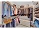 Organized walk-in closet with shelving, hanging rods, and storage trunk maximizing space at 11870 Tevare Ln # 2086, Las Vegas, NV 89138