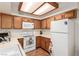 Bright kitchen with white appliances and wood cabinets at 1575 W Warm Springs Rd # 1113, Henderson, NV 89014