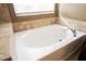 Oval bathtub with tile surround and modern fixtures at 189 Carneros Ave, Henderson, NV 89002