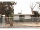 House exterior featuring a green painted house with white fence and landscaping at 2208 Wengert Ave, Las Vegas, NV 89104