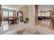 Elegant entryway showcasing the dining and living spaces with plantation shutters and neutral tile flooring at 2425 Amatrice St, Henderson, NV 89044