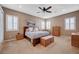 Serene main bedroom with carpeted floor, shuttered windows, ceiling fan, and a comfortable sitting area at 2425 Amatrice St, Henderson, NV 89044