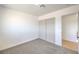 Bright bedroom with gray carpet and double door closet at 2504 Clayton St, North Las Vegas, NV 89032