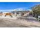 Front view of the house with a carport and gravel landscaping at 2504 Clayton St, North Las Vegas, NV 89032