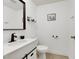 Stylish half-bathroom featuring modern fixtures, vanity with white countertop, and black accents at 3473 Monte Carlo Dr, Las Vegas, NV 89121